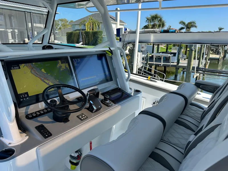 Slide: The Image of 2025 Yellowfin 42 CC boat cockpit with advanced navigation screens and plush seating. - 32