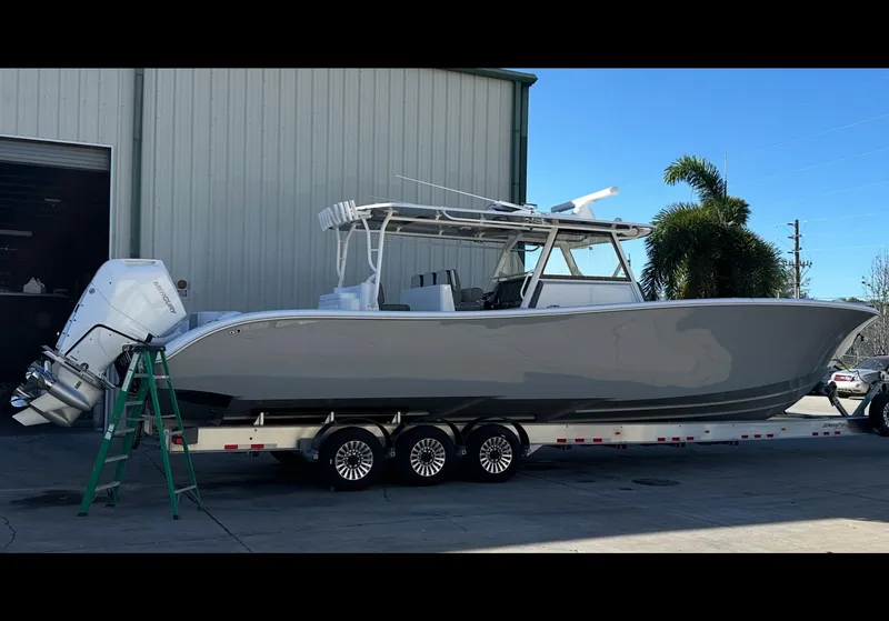 Slide: The Image of 2025 Yellowfin 42 CC boat on trailer, parked outdoors. - 4