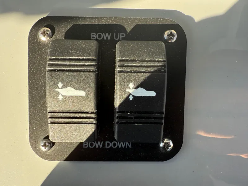 Slide: The Image of 2025 Yellowfin 42 CC boat control panel with bow up and down switches. - 42