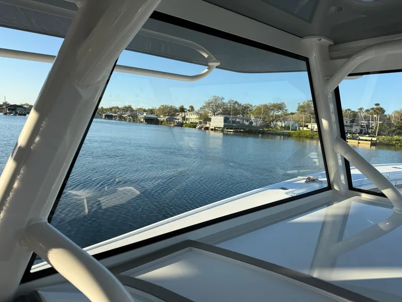 Slide: The Image of 2025 Yellowfin 42 CC boat interior view overlooking serene waterfront homes. - 47