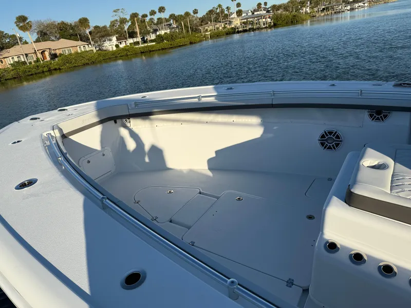 Slide: The Image of 2025 Yellowfin 42 CC boat interior with seating, on a calm waterway. - 53