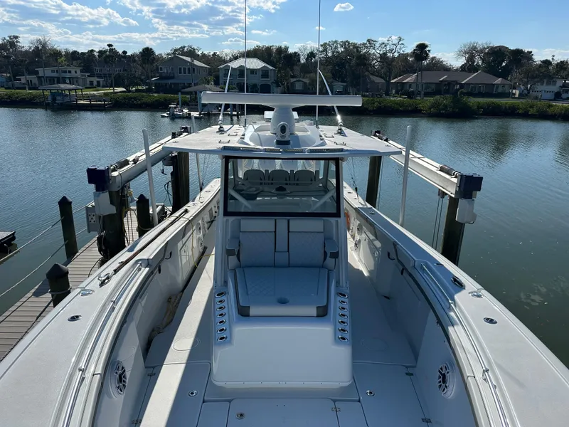 Slide: The Image of 2025 Yellowfin 42 CC boat docked by a scenic waterfront. - 55