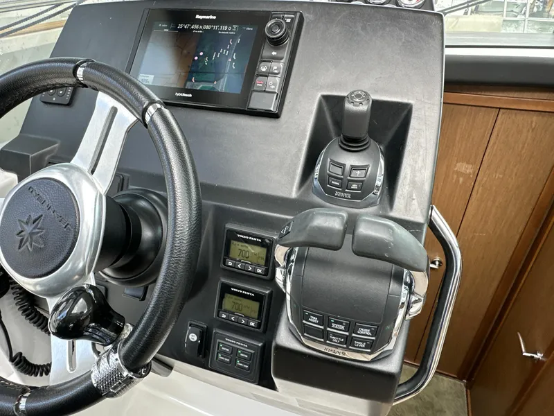 Slide: The Image of Steering console of 2017 Jeanneau NC 11 boat with navigation controls and display. - 12