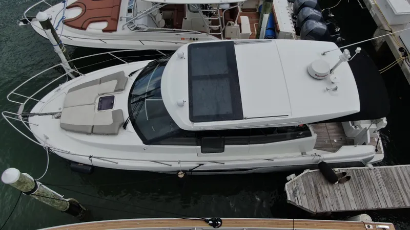 Slide: The Image of 2017 Jeanneau NC 11 boat docked at marina, aerial view. - 2