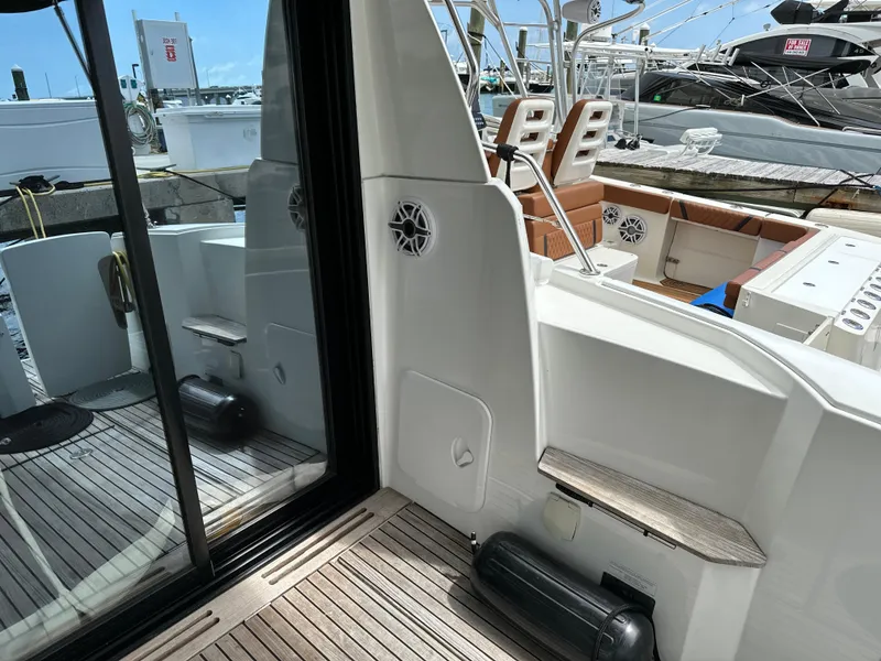 Slide: The Image of 2017 Jeanneau NC 11 yacht deck with wooden flooring and seating area. - 20