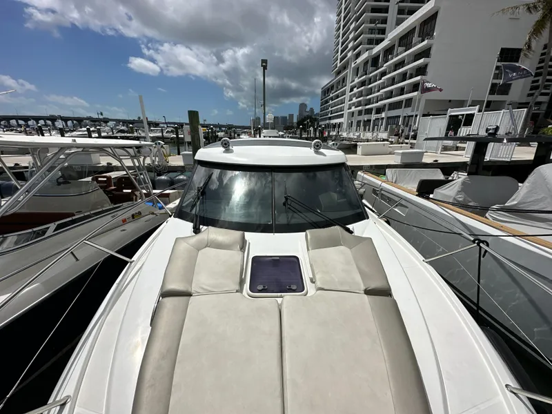 Slide: The Image of 2017 Jeanneau NC 11 yacht docked at marina, featuring spacious sunbathing area. - 26