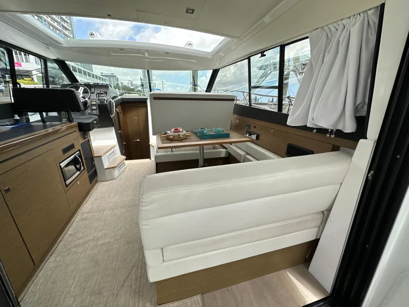 Slide: The Image of Interior of 2017 Jeanneau NC 11 yacht with modern seating and dining area. - 27