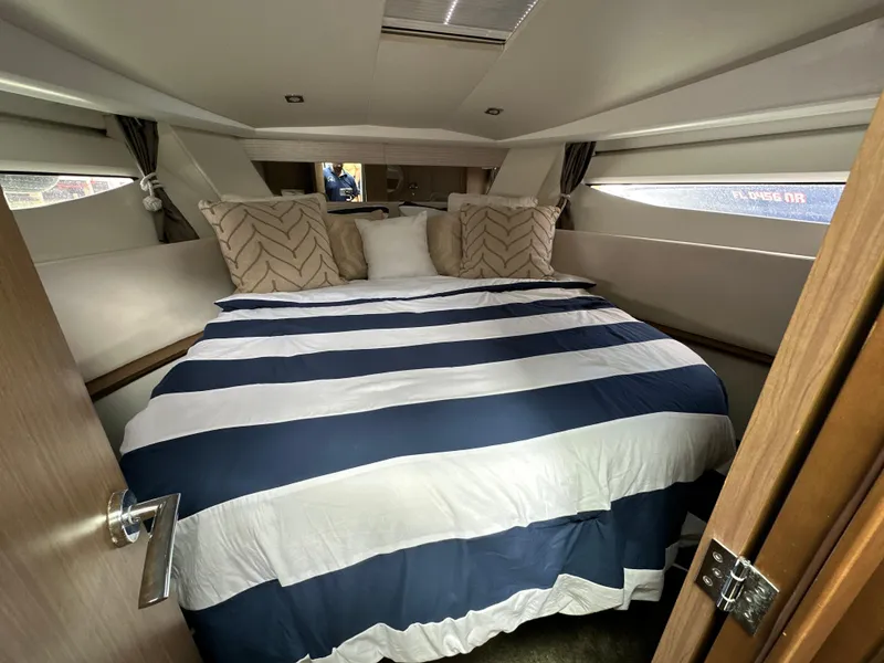 Slide: The Image of Luxurious cabin interior of 2017 Jeanneau NC 11 yacht with striped bedding. - 35
