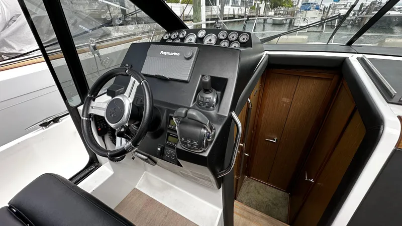 Slide: The Image of 2017 Jeanneau NC 11 helm with modern controls and navigation equipment. - 4