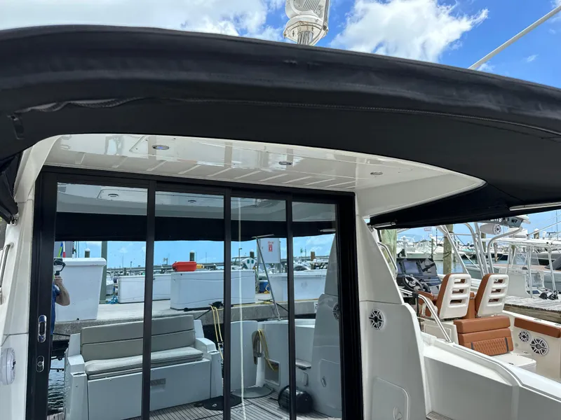 Slide: The Image of 2017 Jeanneau NC 11 boat interior with sliding glass doors and seating area. - 41