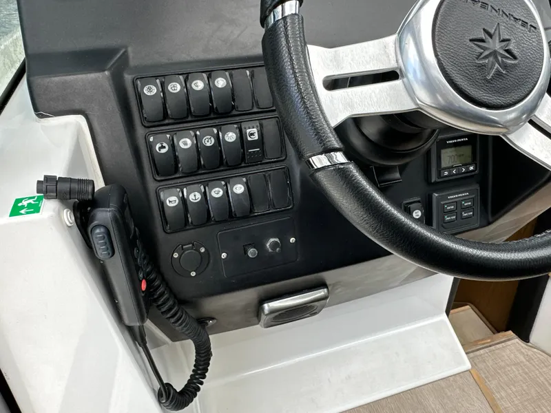 Slide: The Image of Control panel and steering wheel of a 2017 Jeanneau NC 11 boat. - 43