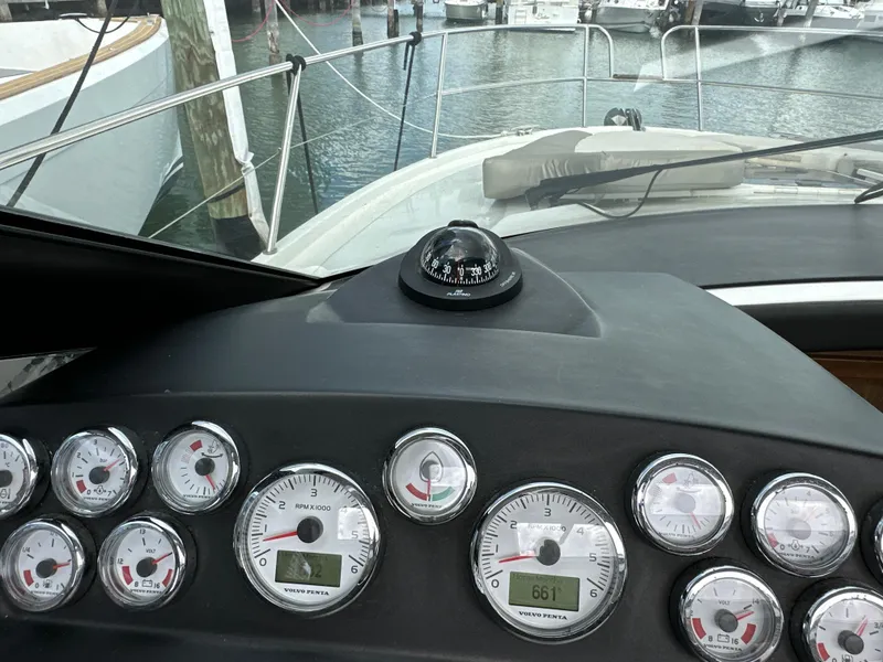 Slide: The Image of Dashboard of a 2017 Jeanneau NC 11 boat with gauges and compass. - 48