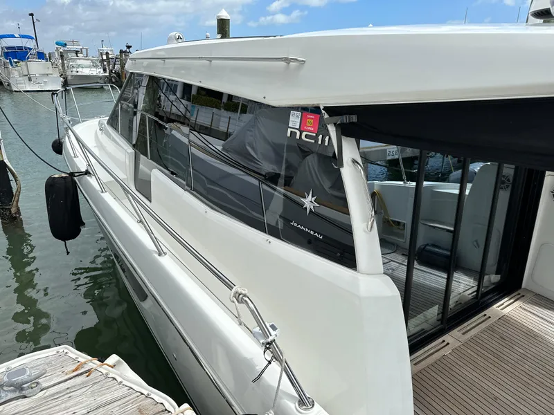 Slide: The Image of 2017 Jeanneau NC 11 yacht docked at marina, side view. - 7