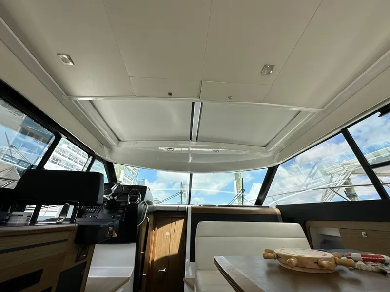 Slide: The Image of Interior view of 2017 Jeanneau NC 11 yacht, featuring modern design and panoramic windows. - 8