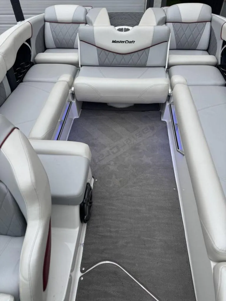 Slide: The Image of 2015 MasterCraft X46 boat interior with gray seating and carpeted floor. - 10