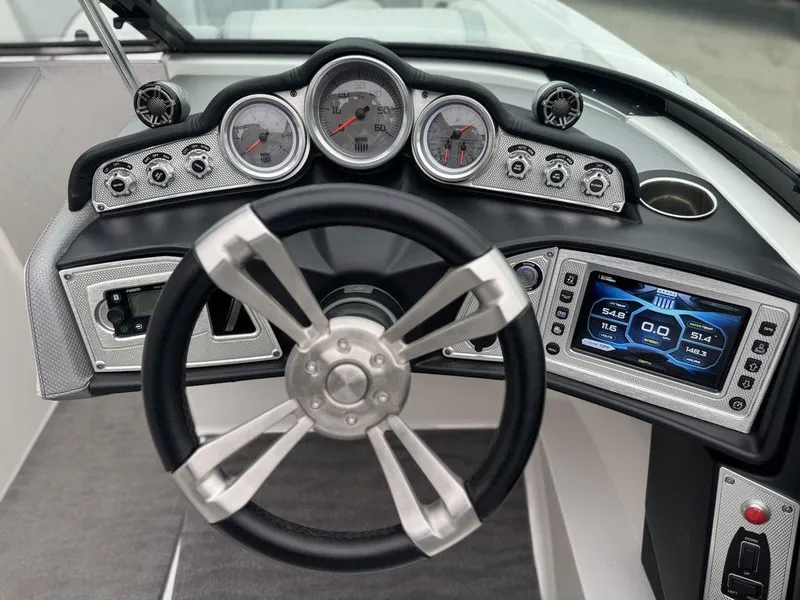 Slide: The Image of 2015 MasterCraft X46 dashboard with steering wheel, gauges, and digital display. - 11