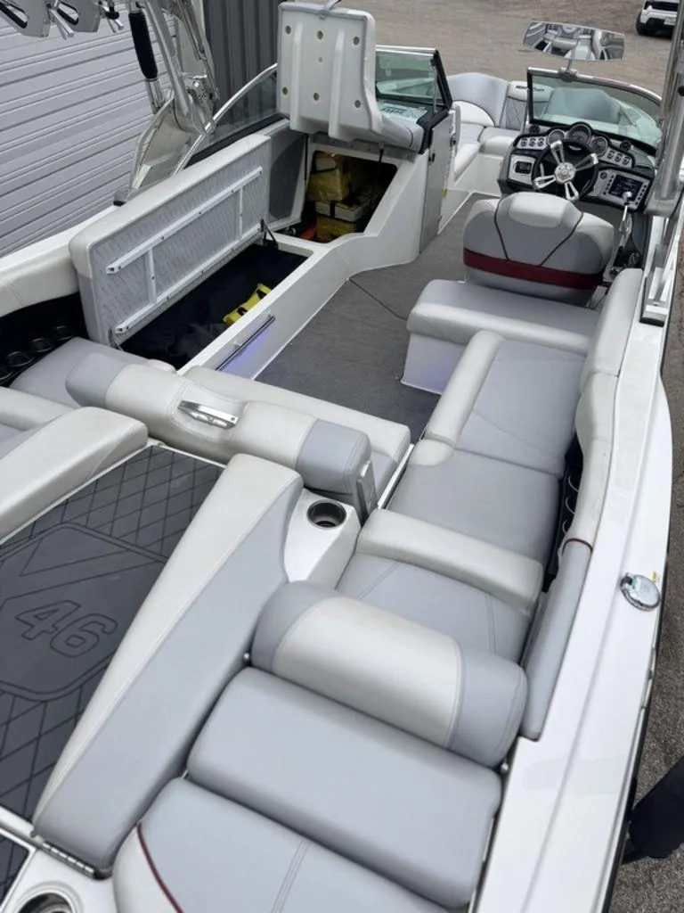 Slide: The Image of 2015 MasterCraft X46 boat interior with gray seating and modern dashboard. - 15