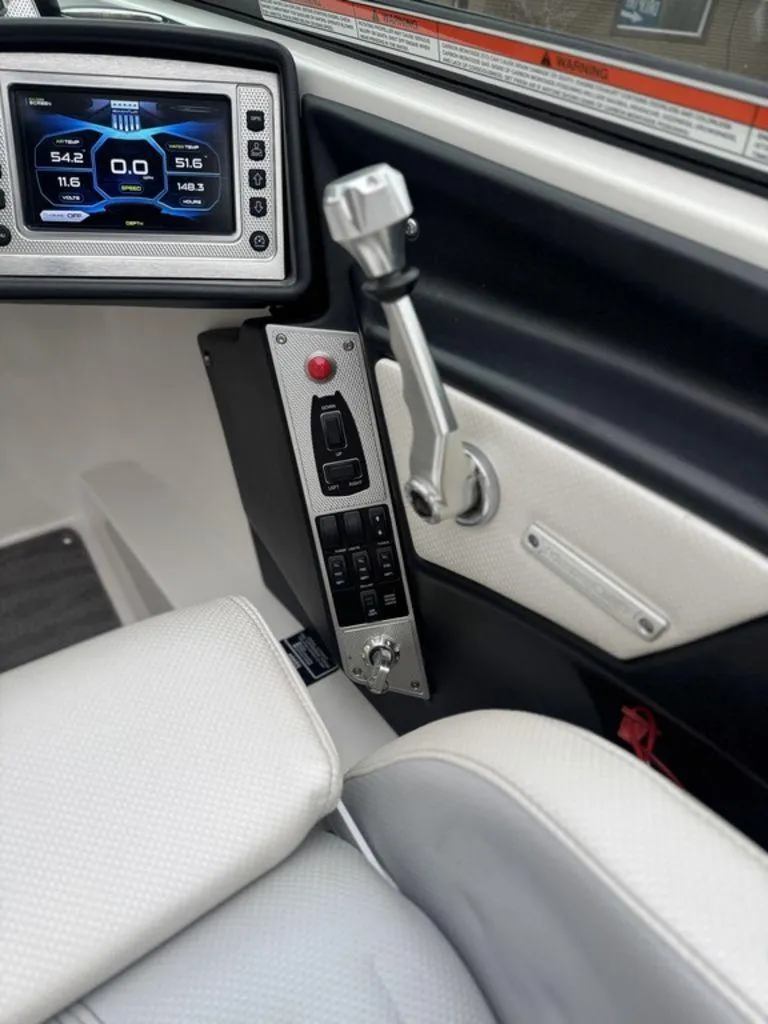 Slide: The Image of 2015 MasterCraft X46 boat dashboard with control panel and digital display. - 16