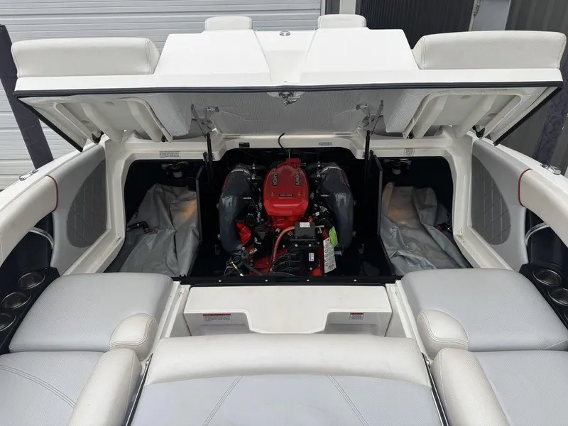 Slide: The Image of 2015 MasterCraft X46 boat engine compartment with open hatch, showcasing red engine. - 18