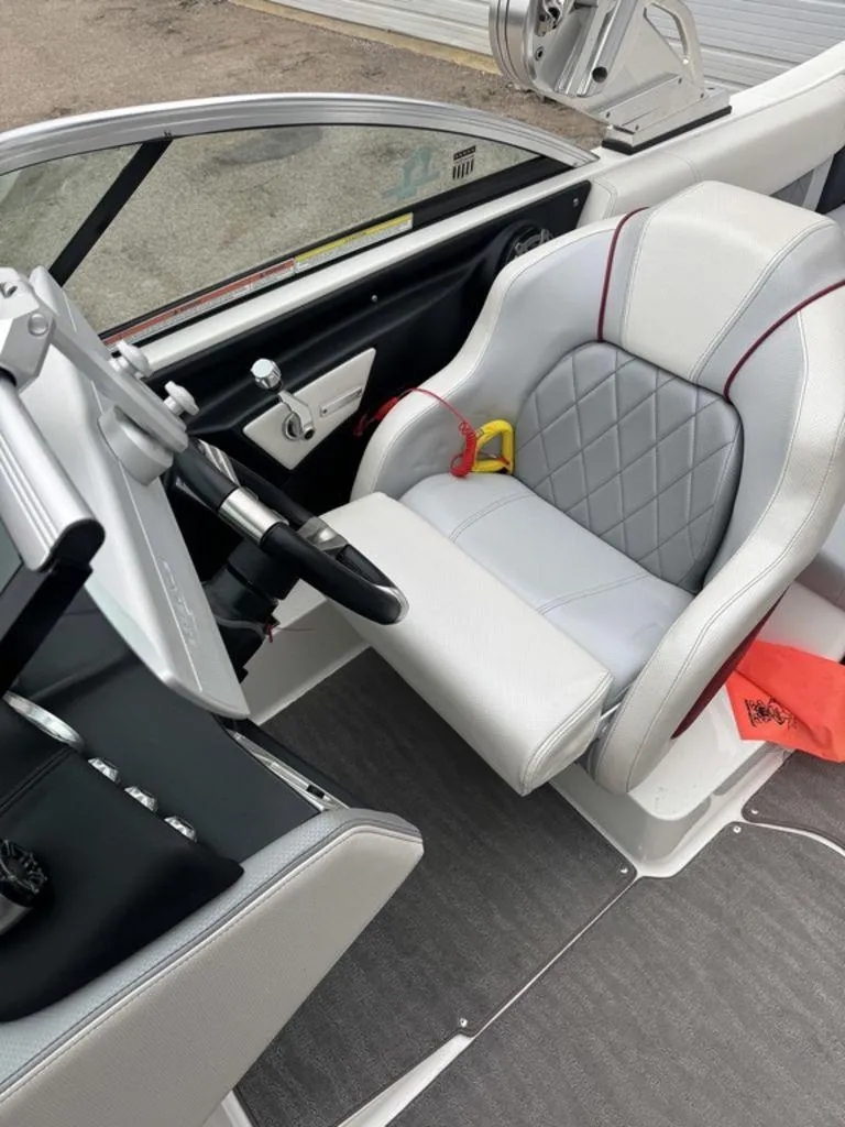 Slide: The Image of 2015 MasterCraft X46 boat interior with sleek captain's seat and modern dashboard. - 2