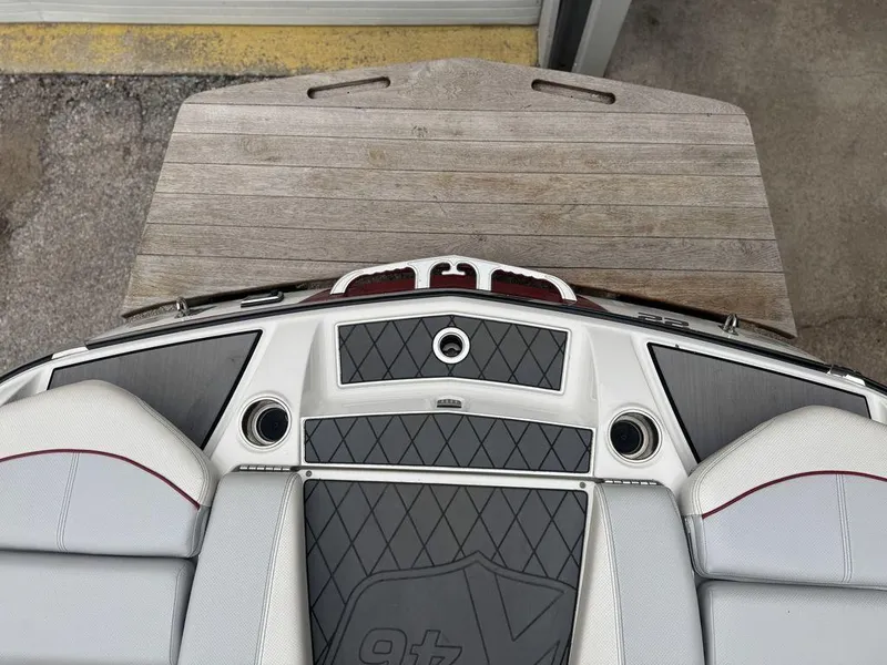 Slide: The Image of 2015 MasterCraft X46 boat interior with cushioned seating and wooden platform. - 20