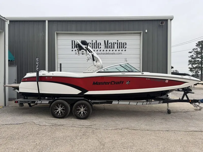 Slide: The Image of 2015 MasterCraft X46 boat in red and white, parked at Dockside Marine. - 22