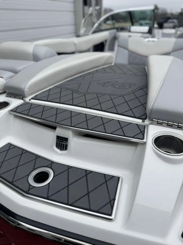 Slide: The Image of 2015 MasterCraft X46 boat interior with cushioned seating and sleek design. - 5
