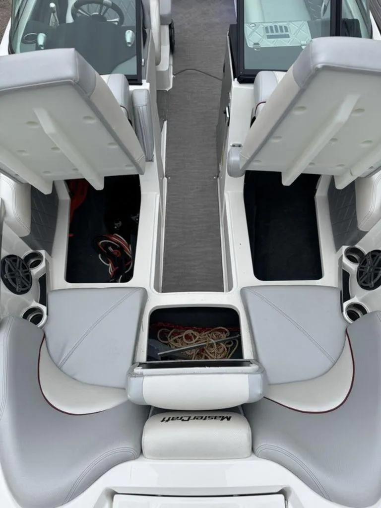 Slide: The Image of 2015 MasterCraft X46 boat interior with gray seating and storage compartments. - 9