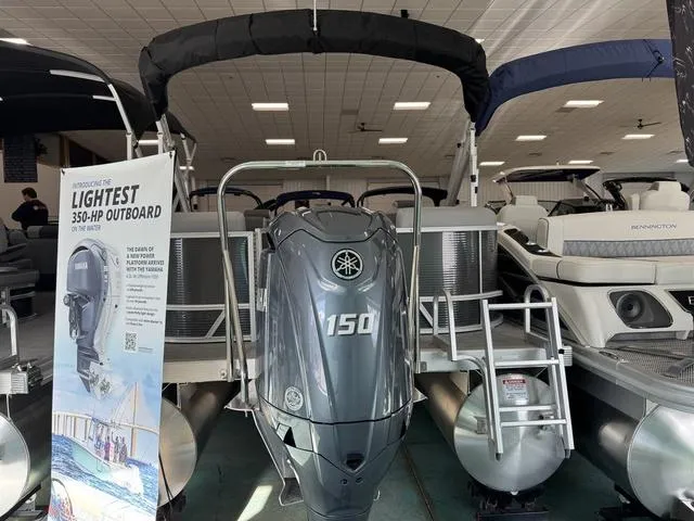 Slide: The Image of 2025 Bennington S Quad Bench 22 SSR with Yamaha 150 outboard motor in showroom. - 10