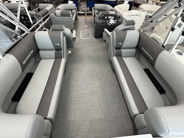 Slide: The Image of 2025 Bennington S Quad Bench 22 SSR pontoon boat interior with gray seating and modern design. - 4