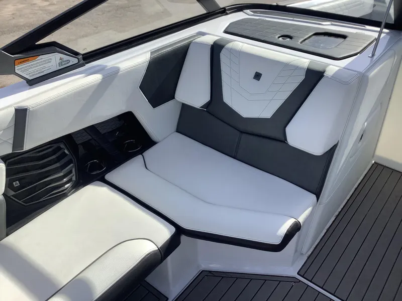 Slide: The Image of 2023 Nautique G21 interior seating with sleek black and white upholstery design. - 6