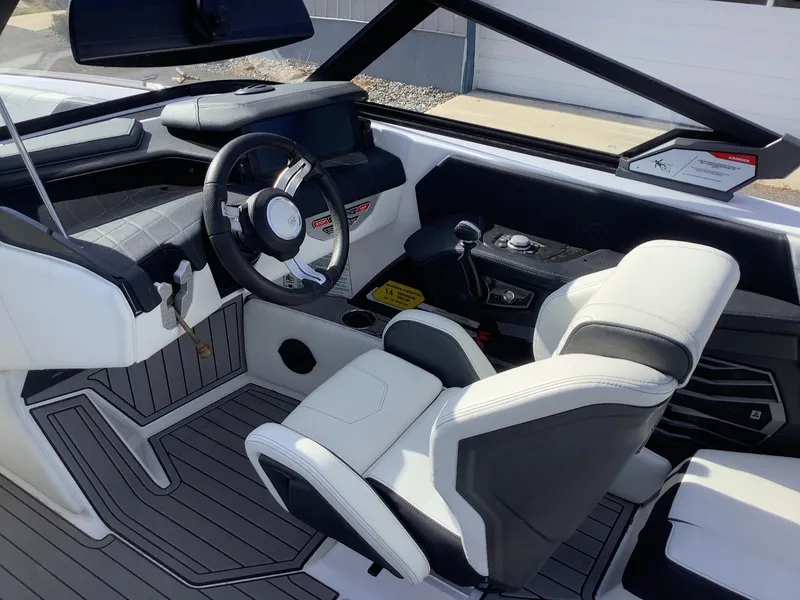 Slide: The Image of 2023 Nautique G21 boat interior with modern steering and seating design. - 7