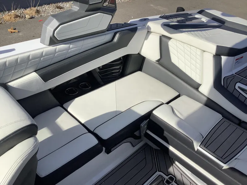 Slide: The Image of 2023 Nautique G21 interior with luxurious white and black seating. - 8