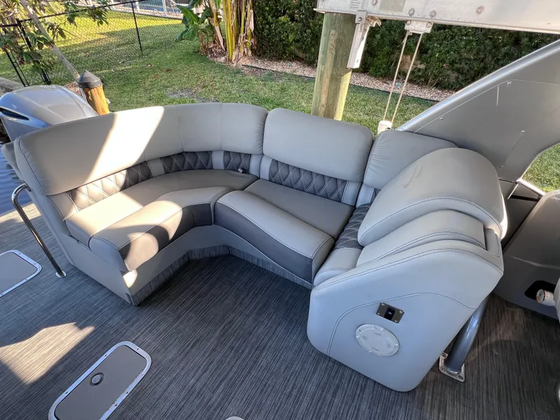 Slide: The Image of Luxurious seating on 2021 Bennington QX 27 pontoon boat with plush gray upholstery. - 14