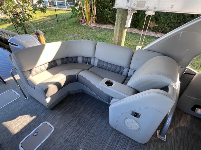 Slide: The Image of 2021 Bennington QX 27 QFB X2 boat interior with gray seating and cup holder. - 15
