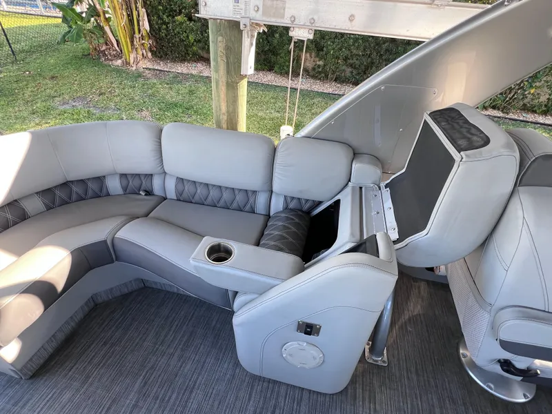 Slide: The Image of Luxurious seating on 2021 Bennington QX 27 pontoon boat with premium upholstery and cup holder. - 16