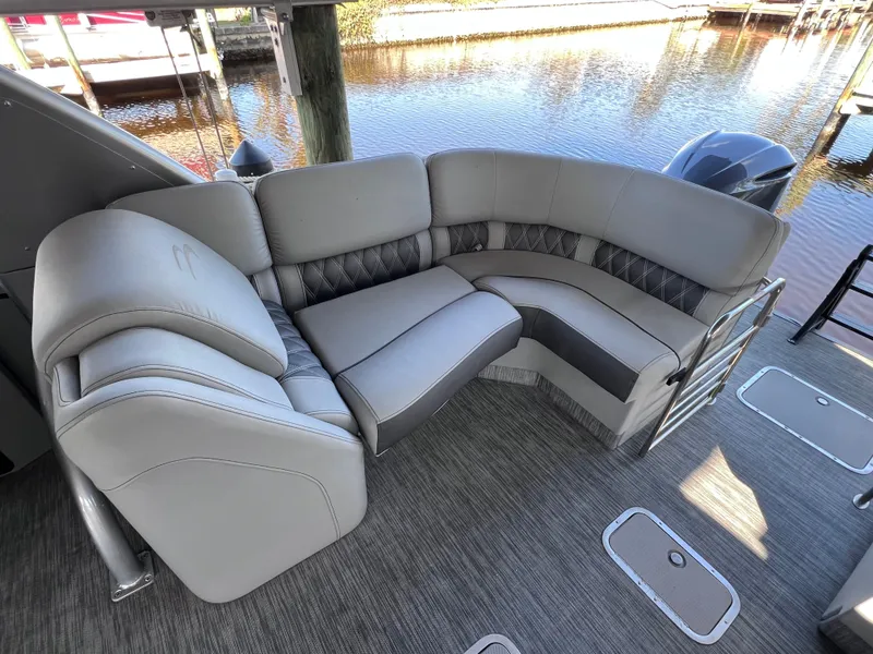 Slide: The Image of Luxurious seating on 2021 Bennington QX 27 pontoon boat, featuring elegant upholstery and spacious design. - 18