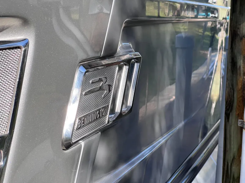 Slide: The Image of 2021 Bennington QX 27 QFB X2 boat emblem on sleek gray surface. - 3