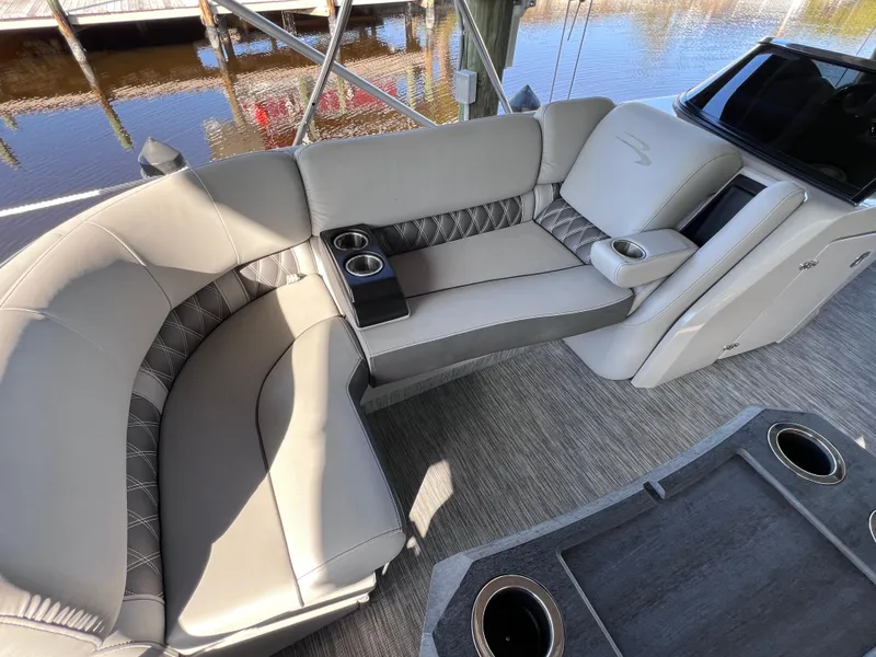 Slide: The Image of Luxurious seating on 2021 Bennington QX 27 pontoon boat with cup holders and elegant design. - 31