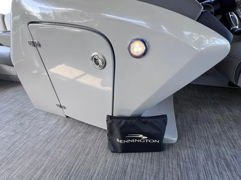Slide: The Image of 2021 Bennington QX 27 QFB X2 boat interior with storage compartment and branded bag. - 35