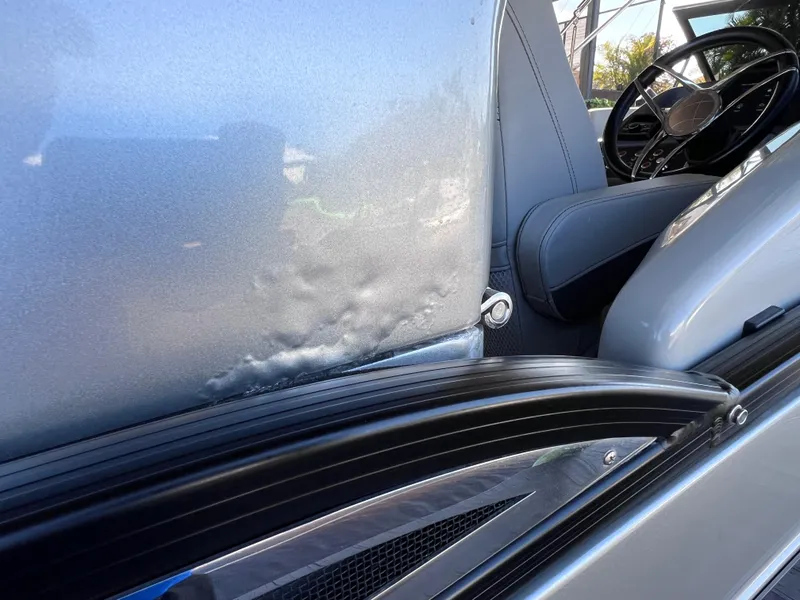 Slide: The Image of 2021 Bennington QX 27 QFB X2 interior with visible seat damage. - 42