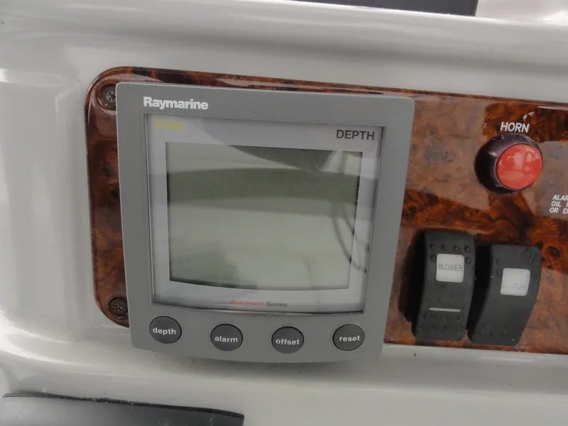 Slide: The Image of Raymarine depth gauge on 2004 Formula 37 PC boat dashboard with controls. - 11