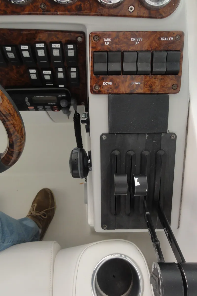 Slide: The Image of Control panel of a 2004 Formula 37 PC boat with switches and throttle levers. - 12