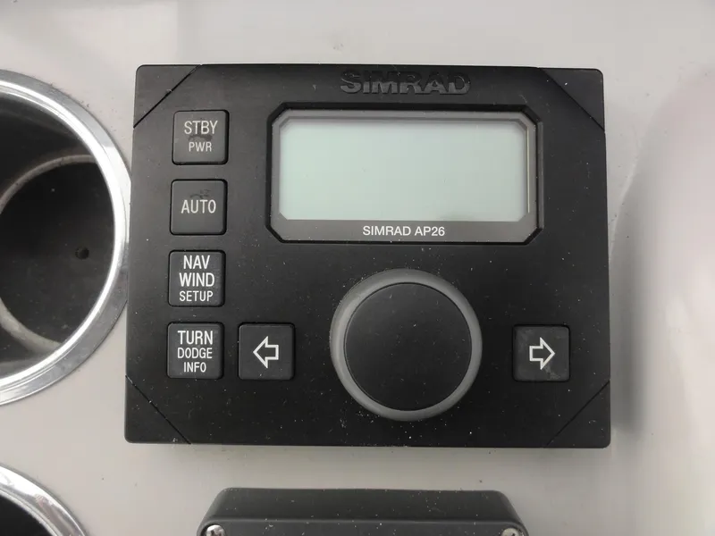 Slide: The Image of Simrad AP26 autopilot control panel on a 2004 Formula 37 PC boat dashboard. - 13