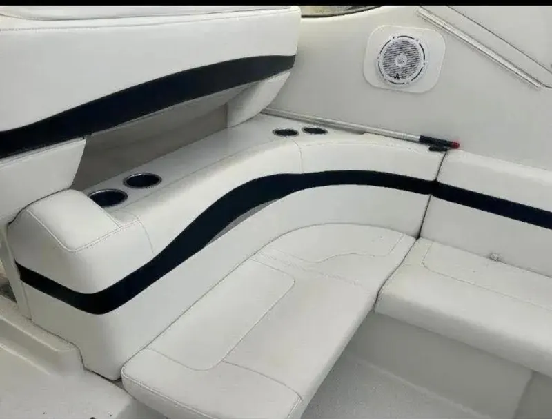 Slide: The Image of 2004 Formula 37 PC boat interior with white seating and cup holders. - 17