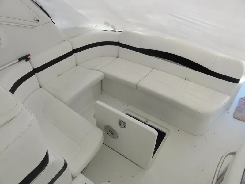 Slide: The Image of 2004 Formula 37 PC boat interior with white seating and storage compartment. - 18