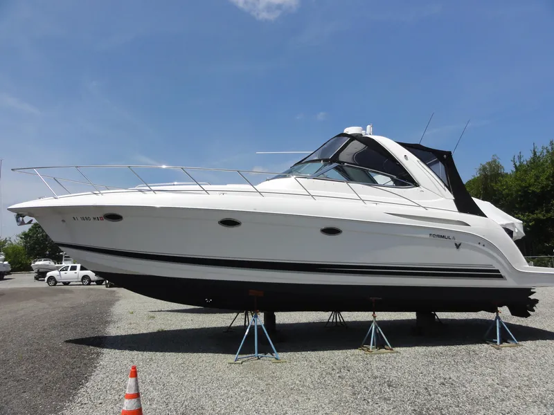Slide: The Image of 2004 Formula 37 PC yacht on stands, displayed outdoors under a clear blue sky. - 2