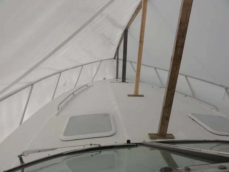 Slide: The Image of 2004 Formula 37 PC boat under protective cover with support beams. - 21