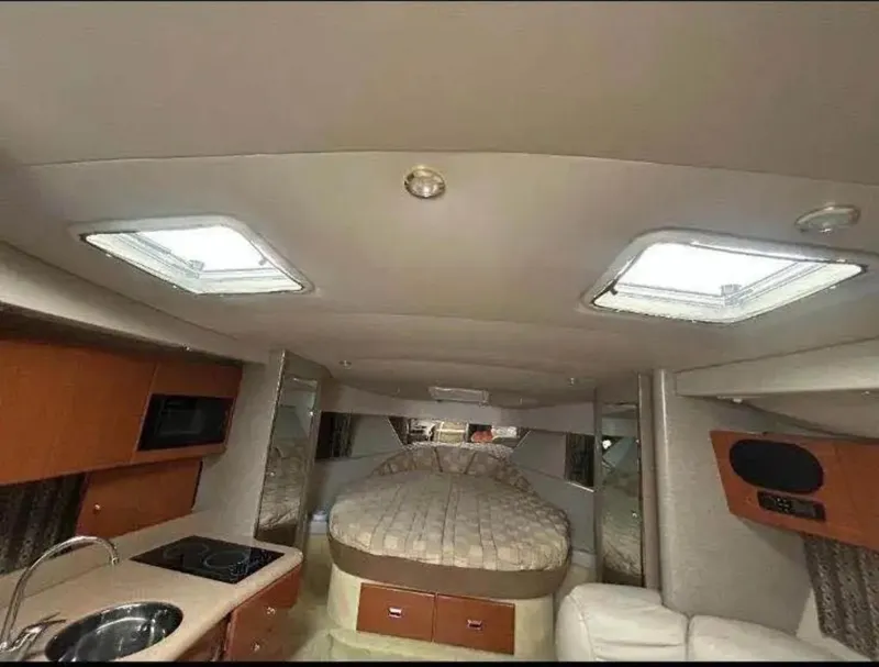 Slide: The Image of 2004 Formula 37 PC yacht interior with bed, kitchenette, and seating area. - 22