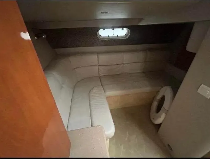 Slide: The Image of 2004 Formula 37 PC cabin interior with beige seating and small window. - 24